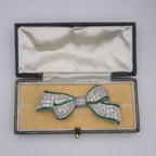 Art Deco Colombian Emerald & Diamond Bow Brooch in Platinum, Circa 1920s